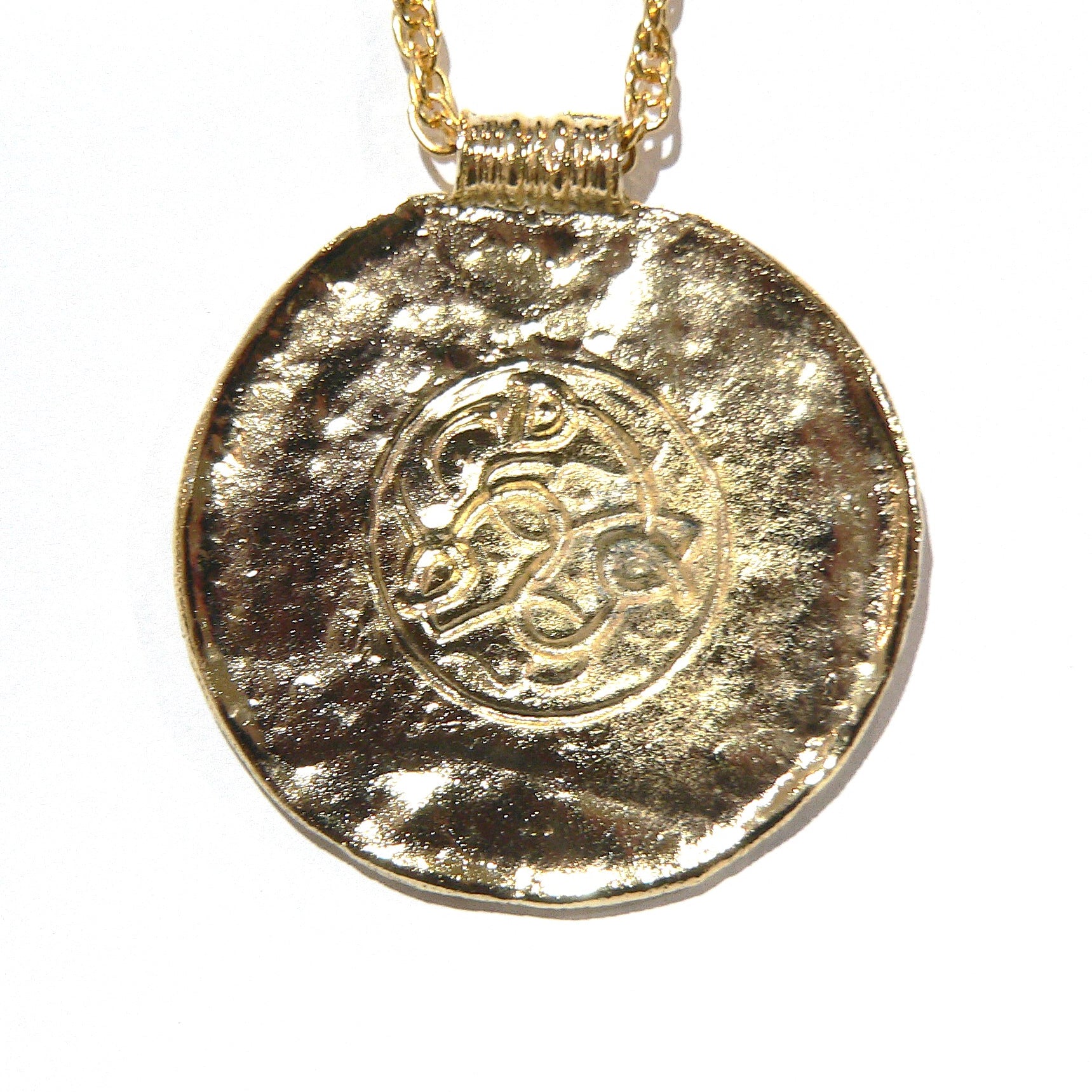 Gold pendant necklace with a textured surface and intricate design a Viking reproduction