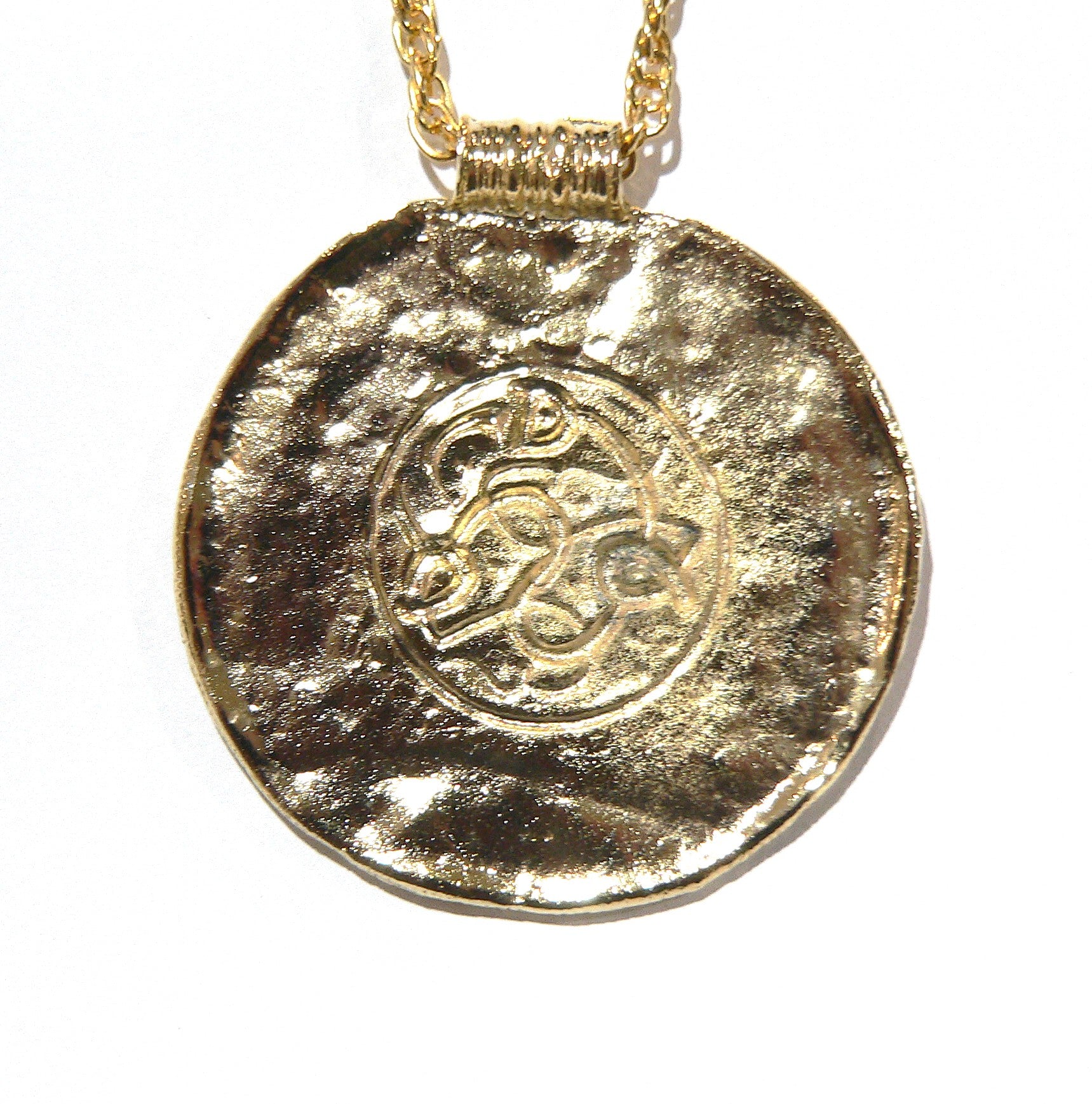 Gold pendant necklace with a textured surface and intricate design a Viking reproduction